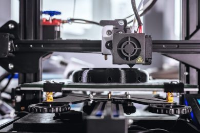 The 3D printer prints black plastic model. modern technology.